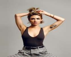 She has tattoos on arm and side back.